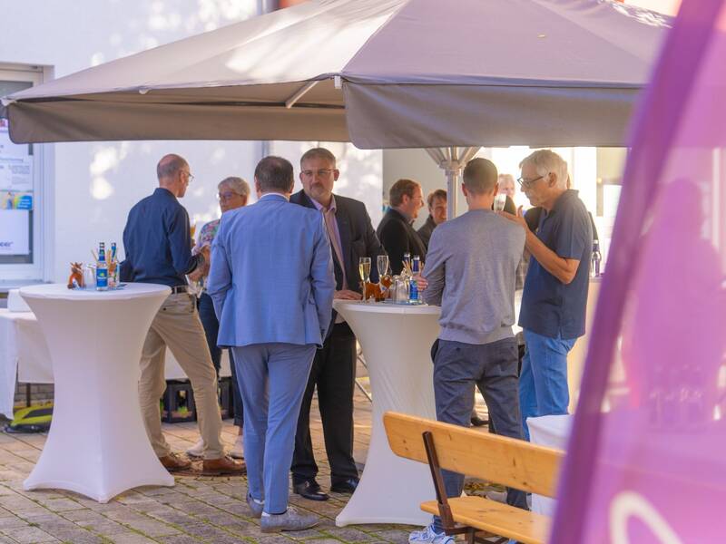 Bürgermeister Rüdiger Klahm spricht bei der Eröffnung des Büros der Energie Althengstett mit interessierten Bürgern.